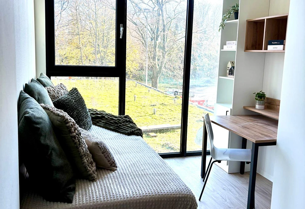Slim ingedeelde studio in Enschede met bed, werkplek en grote raampartijen